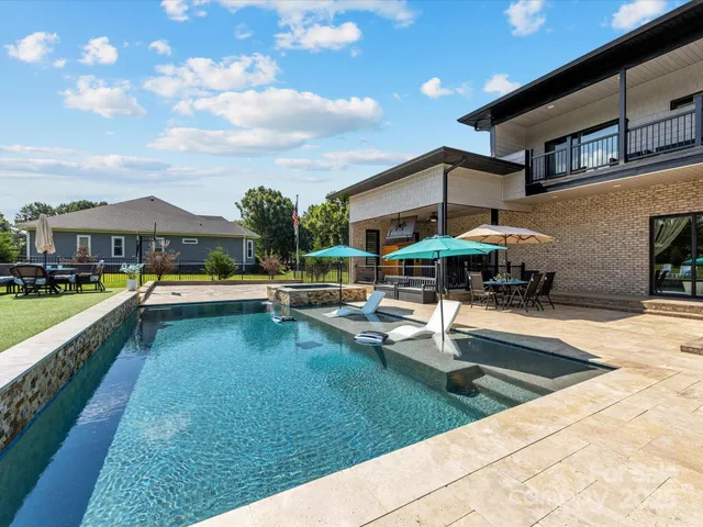 a view of swimming pool with outdoor seating