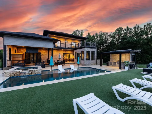 a view of a house with a backyard patio and a garden