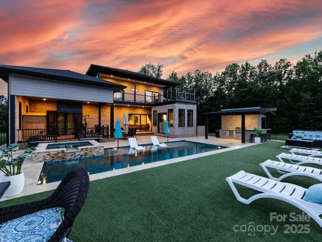 a view of a house with swimming pool and porch