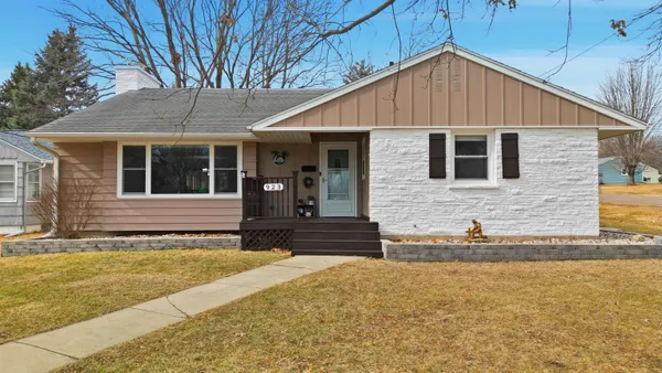 a view of a house with a garage and yard