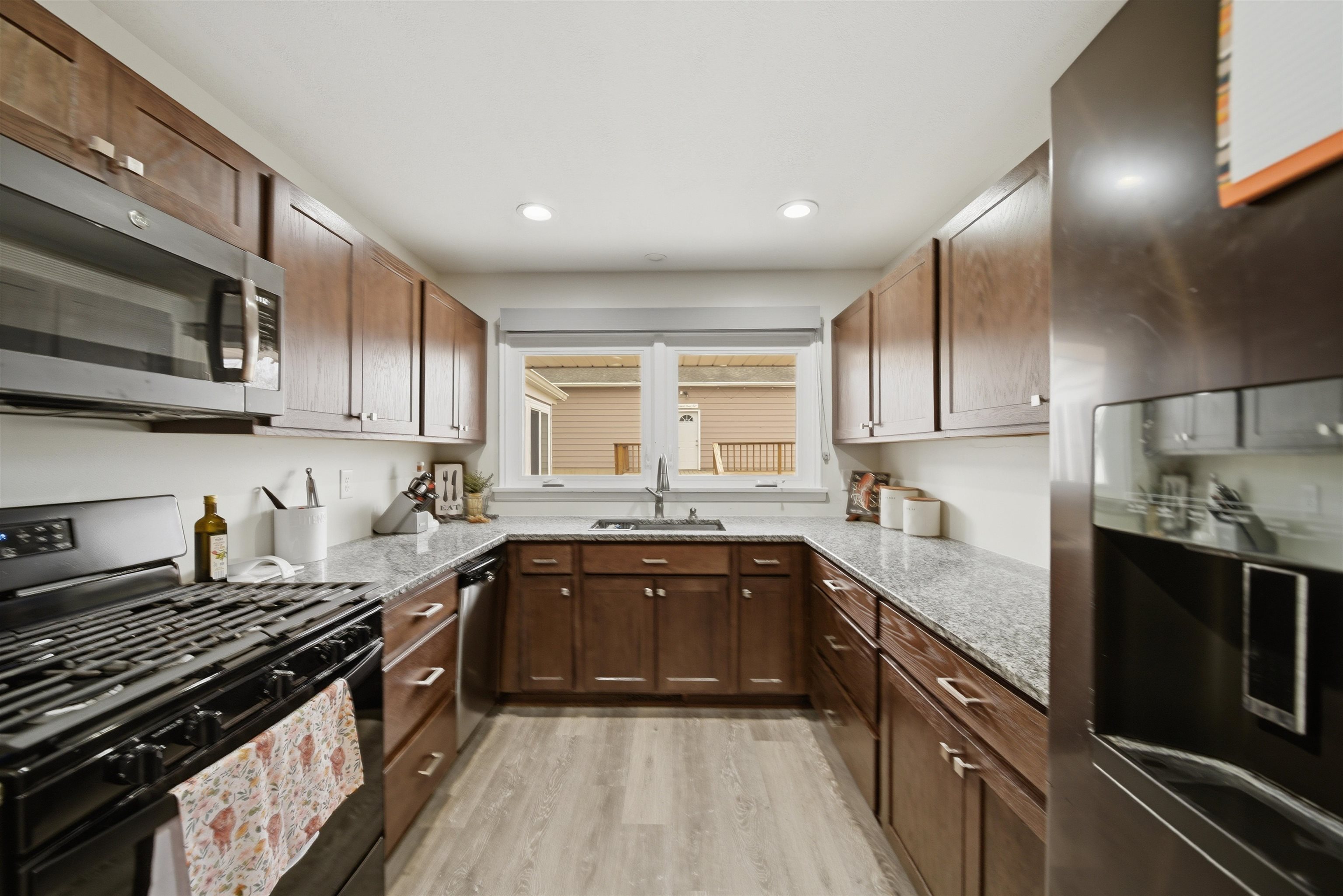 923 Institute Boulevard Dixon, IL 61021 - Photo 17 of 37 a kitchen with stainless steel appliances granite countertop sink stove and refrigerator