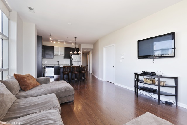 225 South Sangamon Street, Unit 512 Chicago, IL 60607 - Photo 4 of 11 a living room with furniture and a flat screen tv