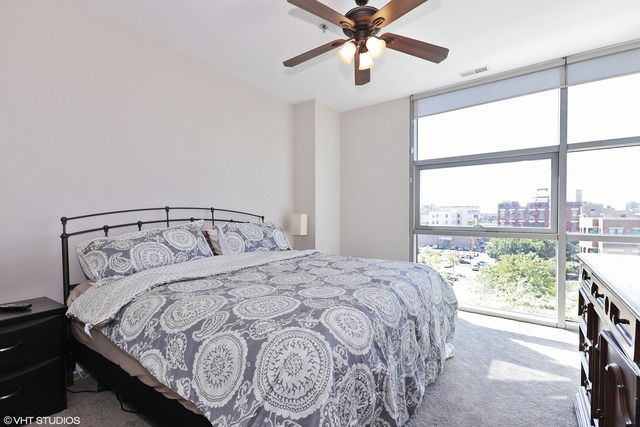 225 South Sangamon Street, Unit 512 Chicago, IL 60607 - Photo 6 of 11 a bedroom with a large bed and a large window