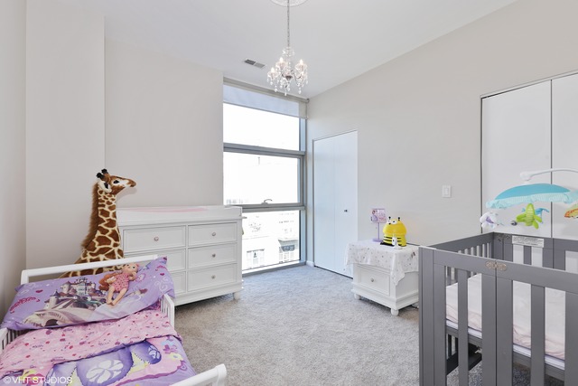225 South Sangamon Street, Unit 512 Chicago, IL 60607 - Photo 8 of 11 a bedroom with furniture and a window