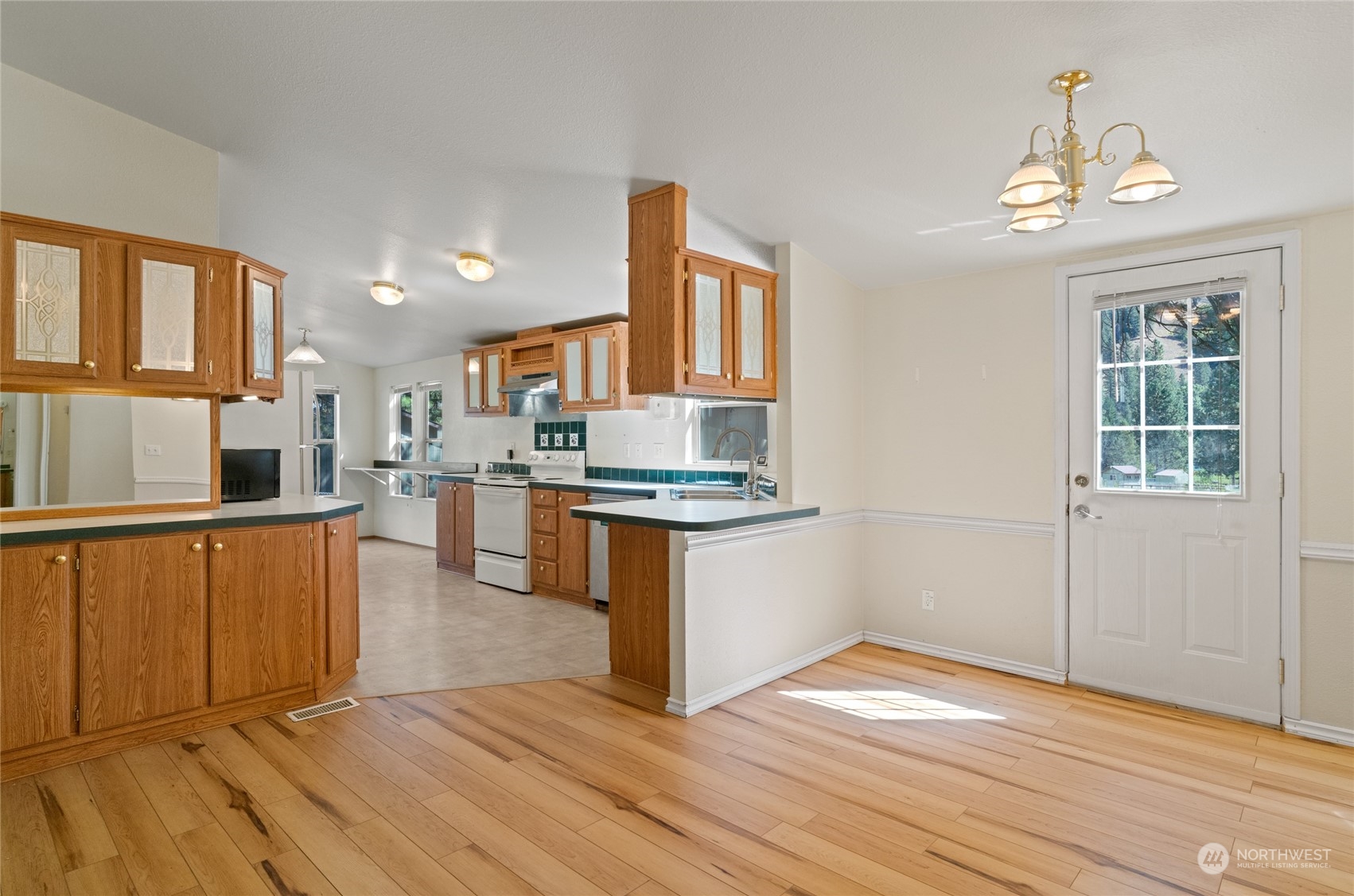 3509 Hansel Lane Peshastin, WA 98847 - Photo 4 of 33 a kitchen with stainless steel appliances granite countertop a stove top oven a sink dishwasher and a refrigerator with wooden floor
