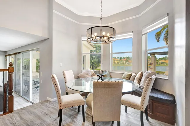 a view of a dining room with furniture wooden floor and chandelier