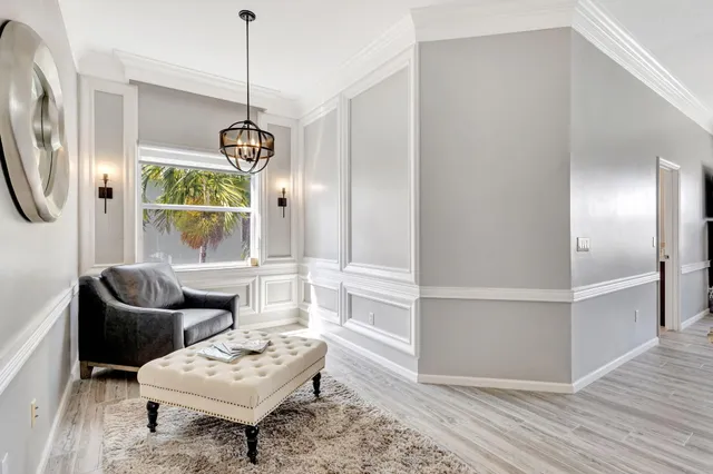 a living room with furniture a window and gym equipment