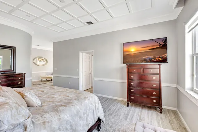 a bedroom with a bed and a flat tv screen in it