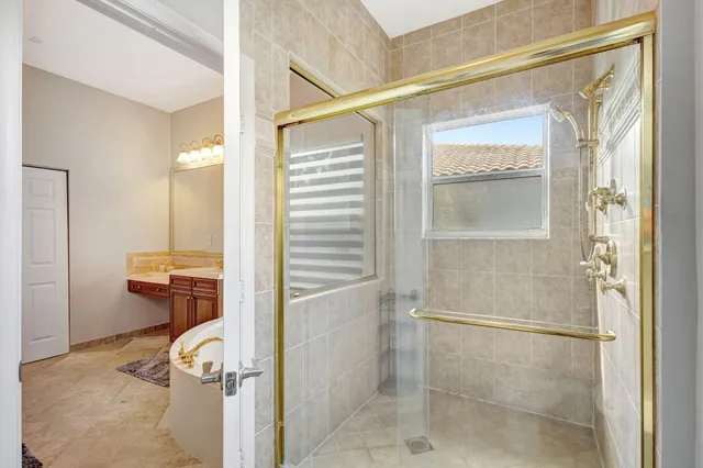 a bathroom with a tub and shower