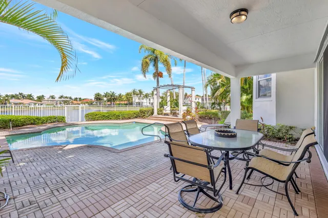 a view of a patio with a table and chairs