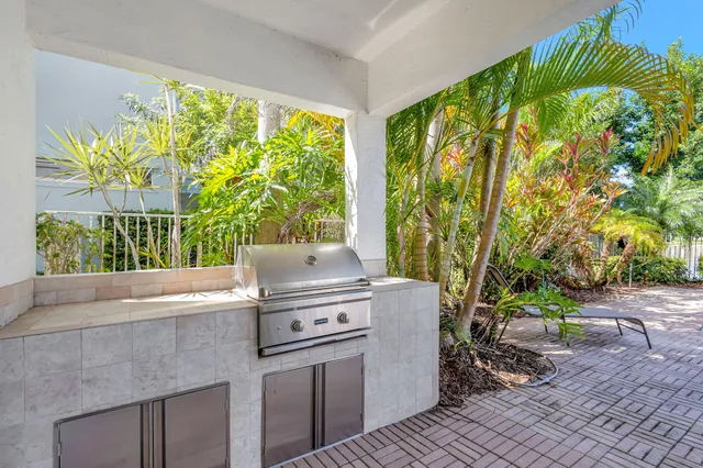 a living room with a floor to ceiling window and a potted plant