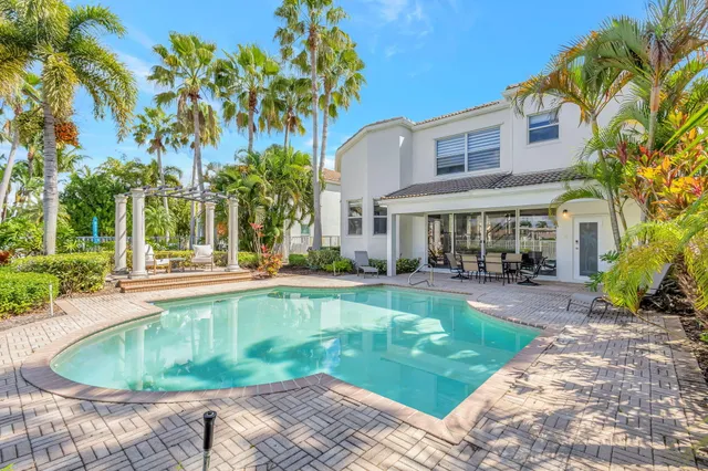 a view of a house with swimming pool and sitting area