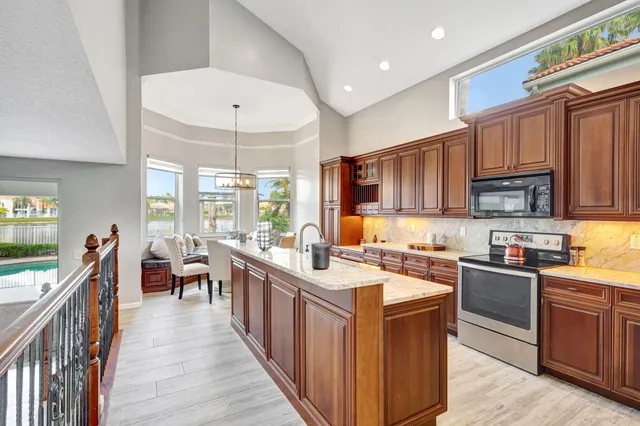 a kitchen with stainless steel appliances a sink stove and cabinets