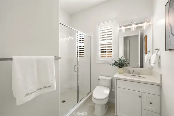 a bedroom with a bed couch and a window