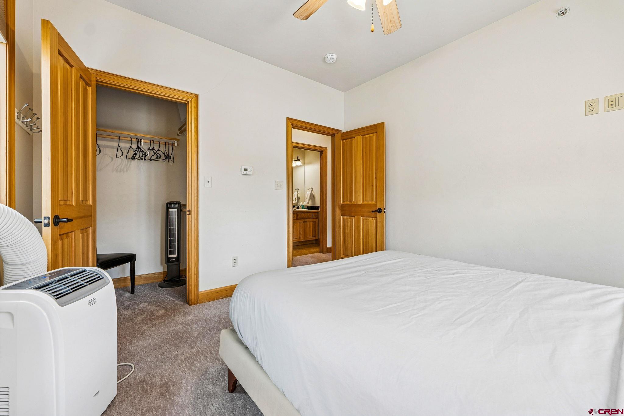 1422 Animas View Drive, Unit 55 Durango, CO 81301 - Photo 33 of 44 a bedroom with a bed and a dresser