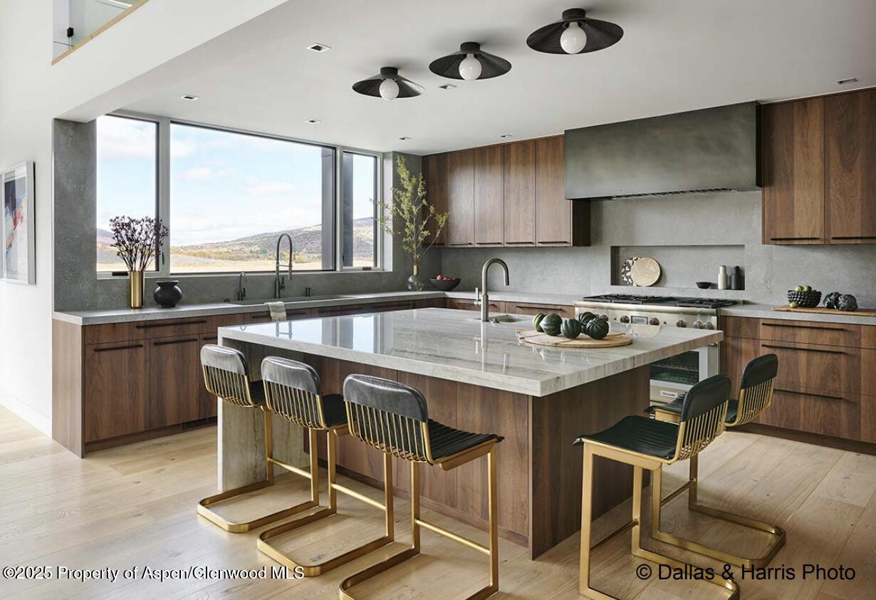 2196 Lazy O Road Snowmass, CO 81654 - Photo 12 of 59 a kitchen with a sink a stove and chairs