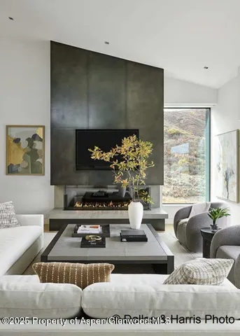 a living room with a couch and a floor to ceiling window