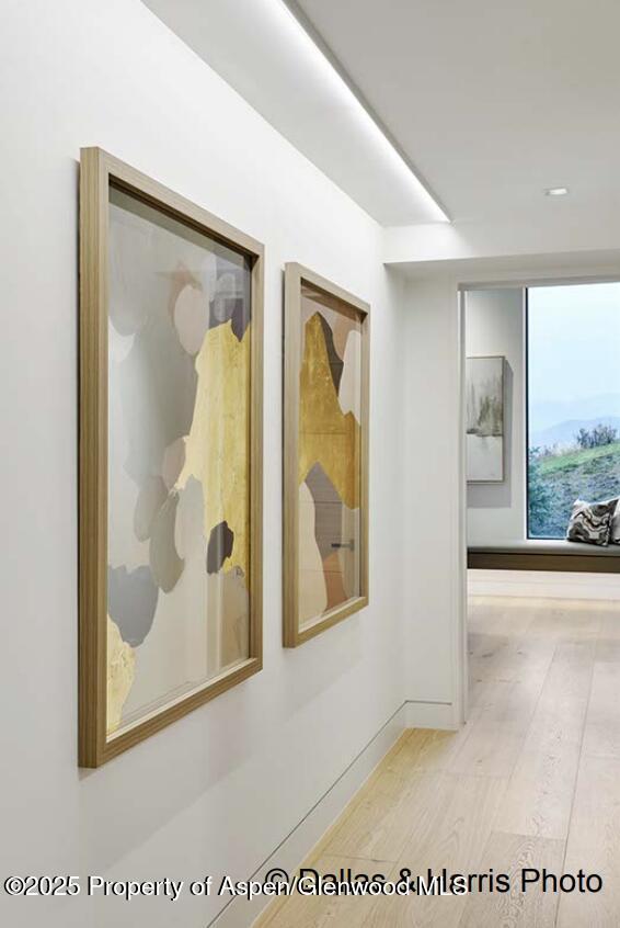 2196 Lazy O Road Snowmass, CO 81654 - Photo 28 of 59 a view of a hallway with wooden floor and a living room