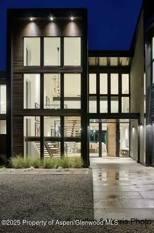 a living room with furniture fireplace and a large window