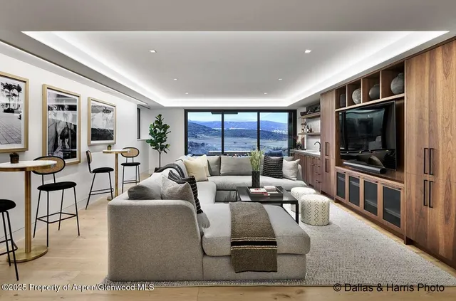 a very nice looking room with a large window and furniture