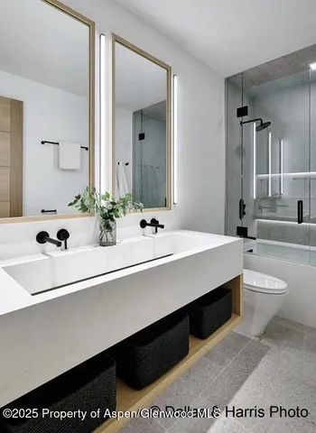 a spacious bathroom with a granite countertop sink mirror and bathtub