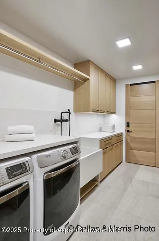 a living room with furniture and wall paintings