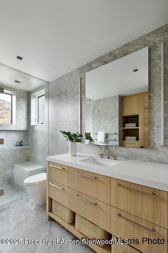 2196 Lazy O Road Snowmass, CO 81654 - Photo 43 of 59 a spacious bathroom with a granite countertop sink mirror and bathtub