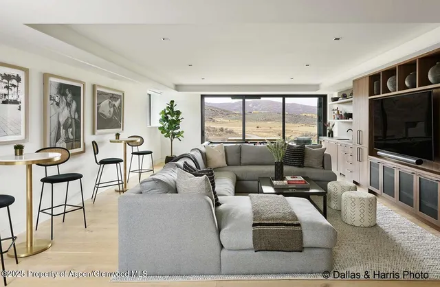 a view of a livingroom with furniture and staircase