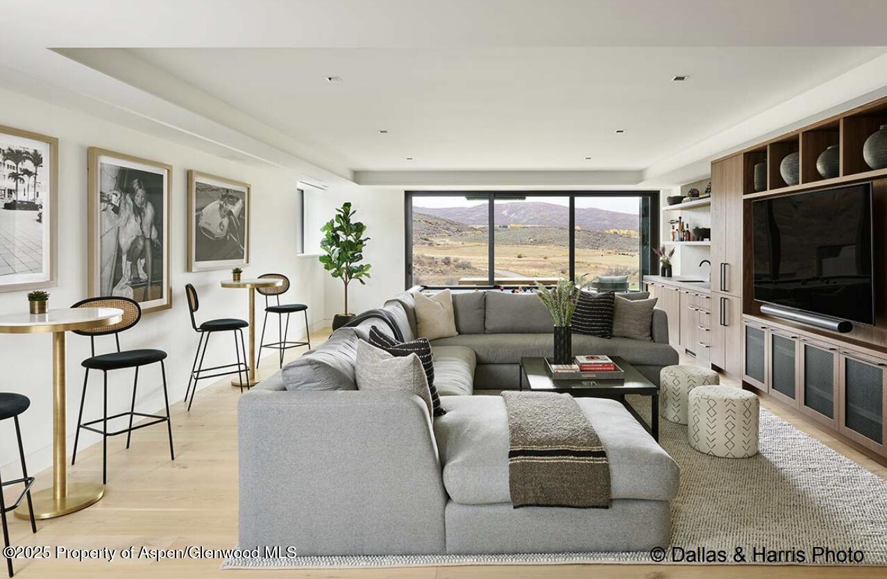 2196 Lazy O Road Snowmass, CO 81654 - Photo 47 of 59 a living room with furniture and a flat screen tv
