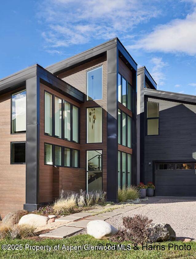 2196 Lazy O Road Snowmass, CO 81654 - Photo 57 of 59 a view of a brick house with many windows