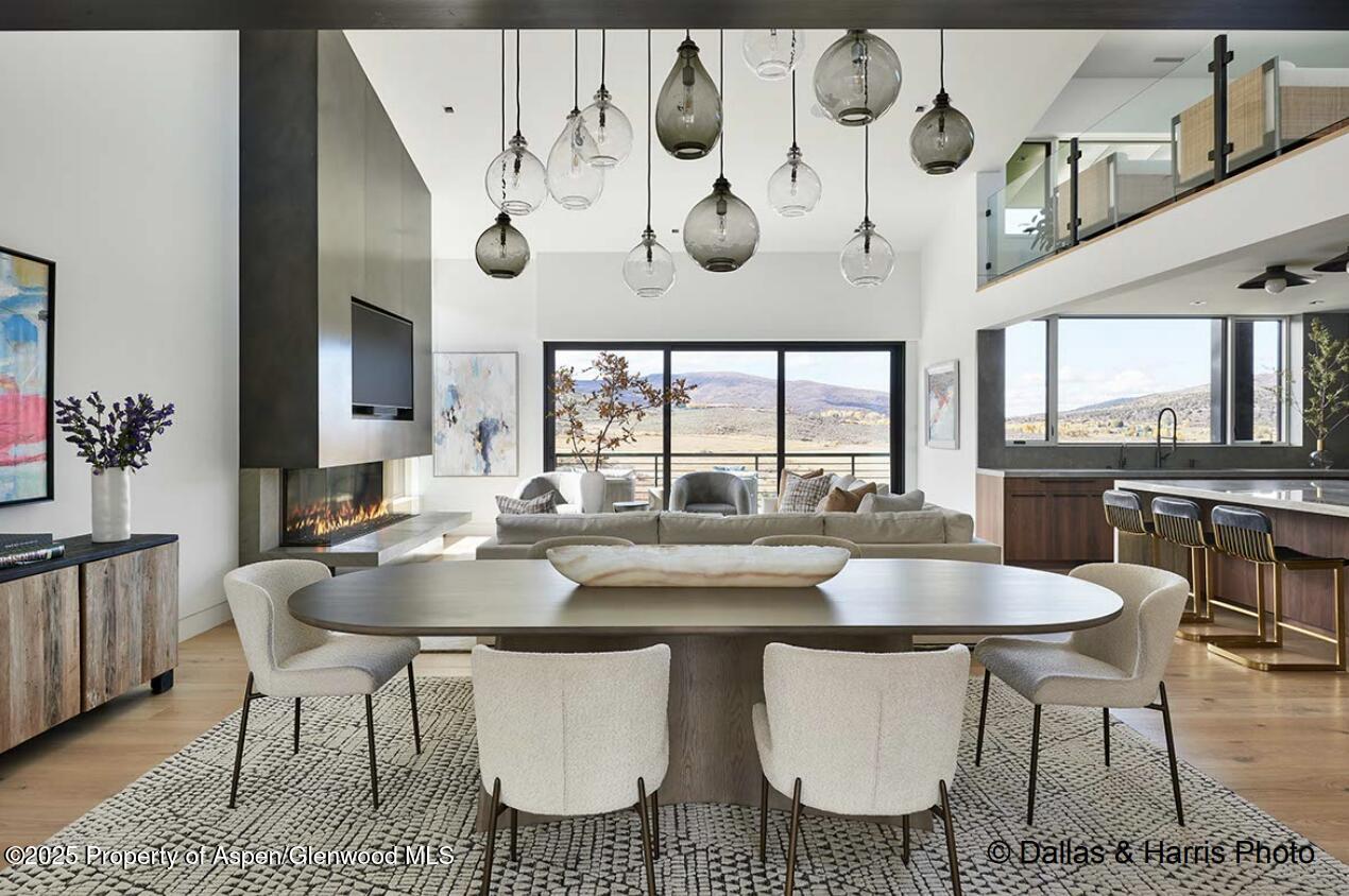 2196 Lazy O Road Snowmass, CO 81654 - Photo 6 of 59 a dining table with chairs and kitchen view