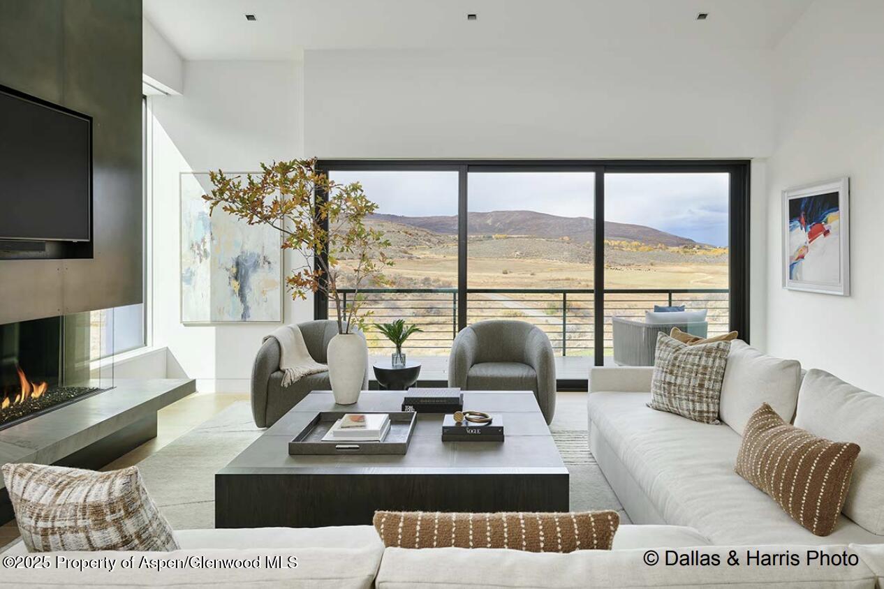 2196 Lazy O Road Snowmass, CO 81654 - Photo 7 of 59 a living room with furniture large window and a flat screen tv