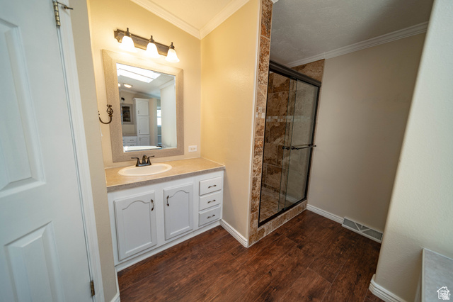 1407 North 1250th Street West Helper, UT 84526 - Photo 18 of 27 Full Mater Bathroom with vanity, a stall shower, ornamental molding, and dark wood-style floors