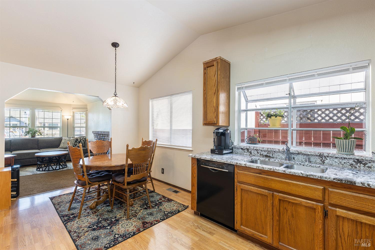 1935 Seville Street Santa Rosa, CA 95403 - Photo 8 of 30 a open kitchen with granite countertop a table and chairs in it