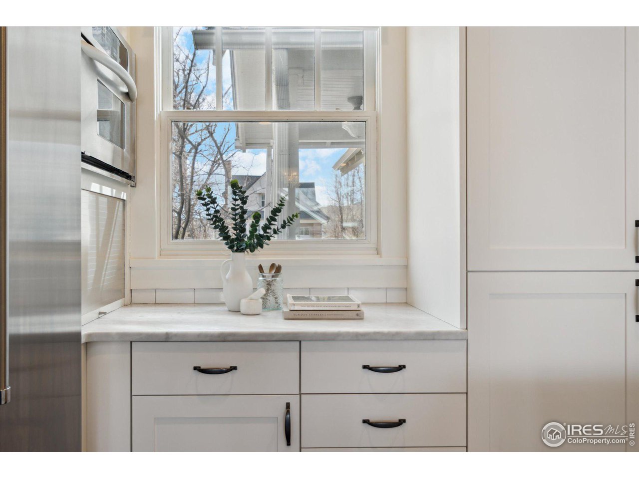 1013 Mapleton Avenue Boulder, CO 80304 - Photo 11 of 37 a bathroom with a sink a mirror and a window