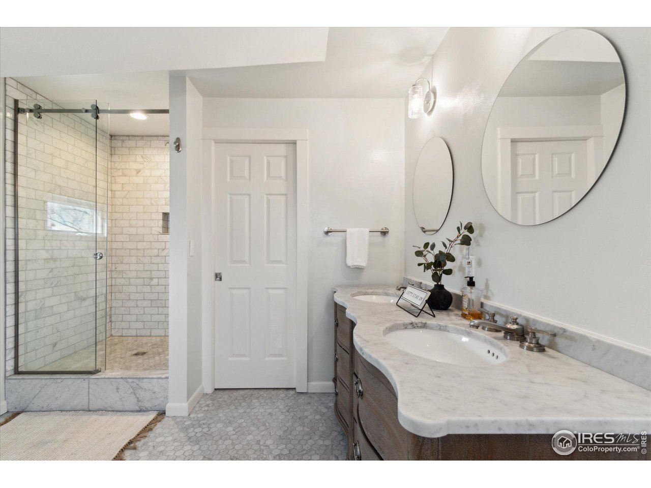1013 Mapleton Avenue Boulder, CO 80304 - Photo 27 of 37 a bathroom with a sink mirror and a shower