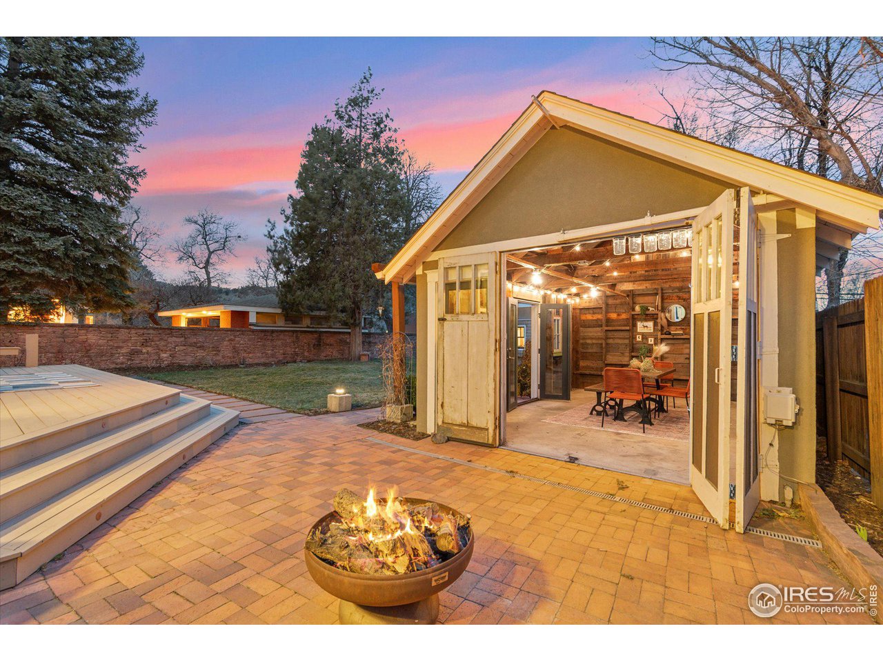 1013 Mapleton Avenue Boulder, CO 80304 - Photo 31 of 37 a view of a backyard with table and chairs under an umbrella