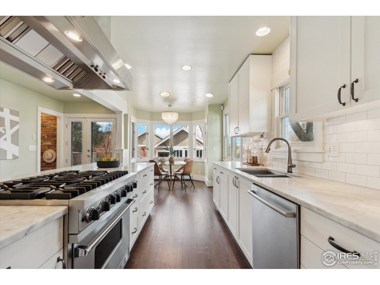 1013 Mapleton Avenue Boulder, CO 80304 - Photo 9 of 37 a kitchen with lots of counter top space and wooden floor