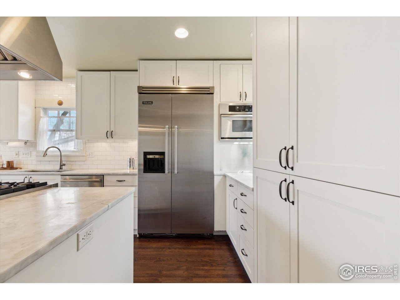 1013 Mapleton Avenue Boulder, CO 80304 - Photo 10 of 37 a kitchen with white cabinets and stainless steel appliances