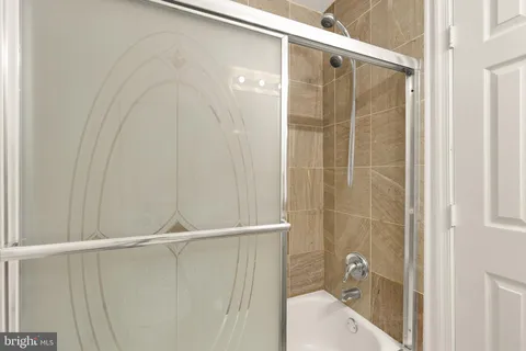a bathroom with a shower and a sink