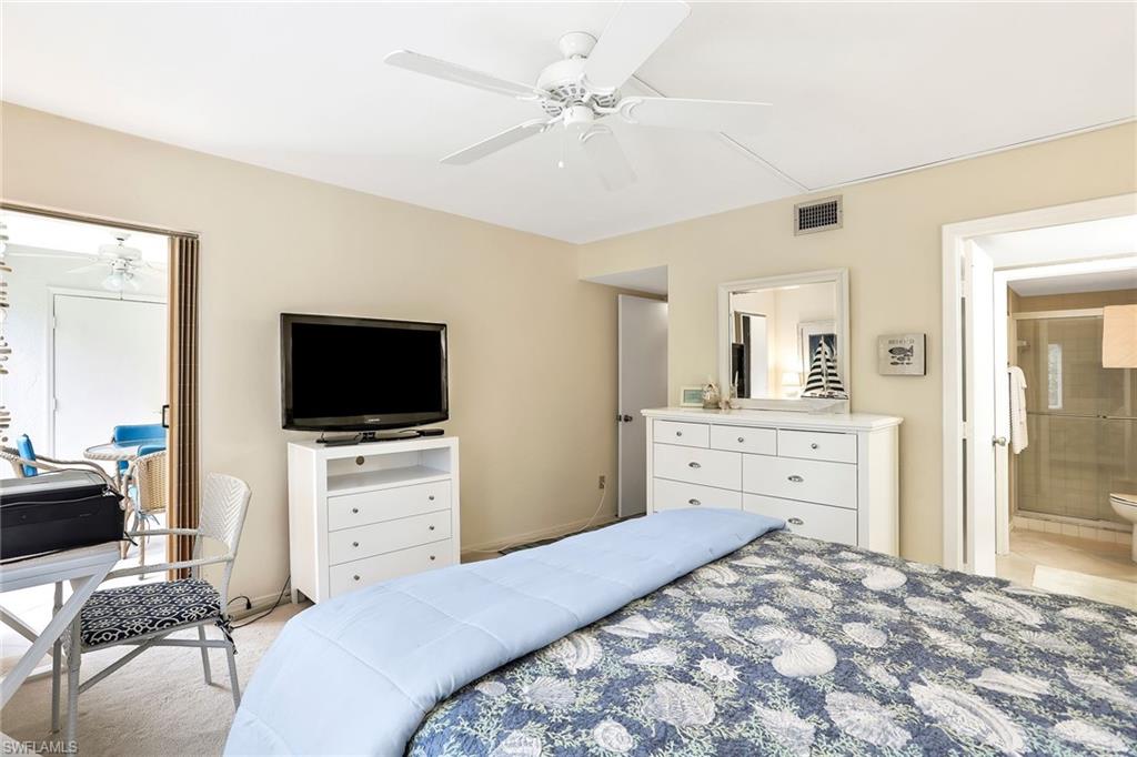 1001 Foxfire Lane, Unit 204 Naples, FL 34104 - Photo 11 of 22 a bedroom with a bed and a flat screen tv