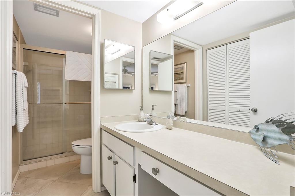 1001 Foxfire Lane, Unit 204 Naples, FL 34104 - Photo 12 of 22 a bathroom with a sink a toilet and shower