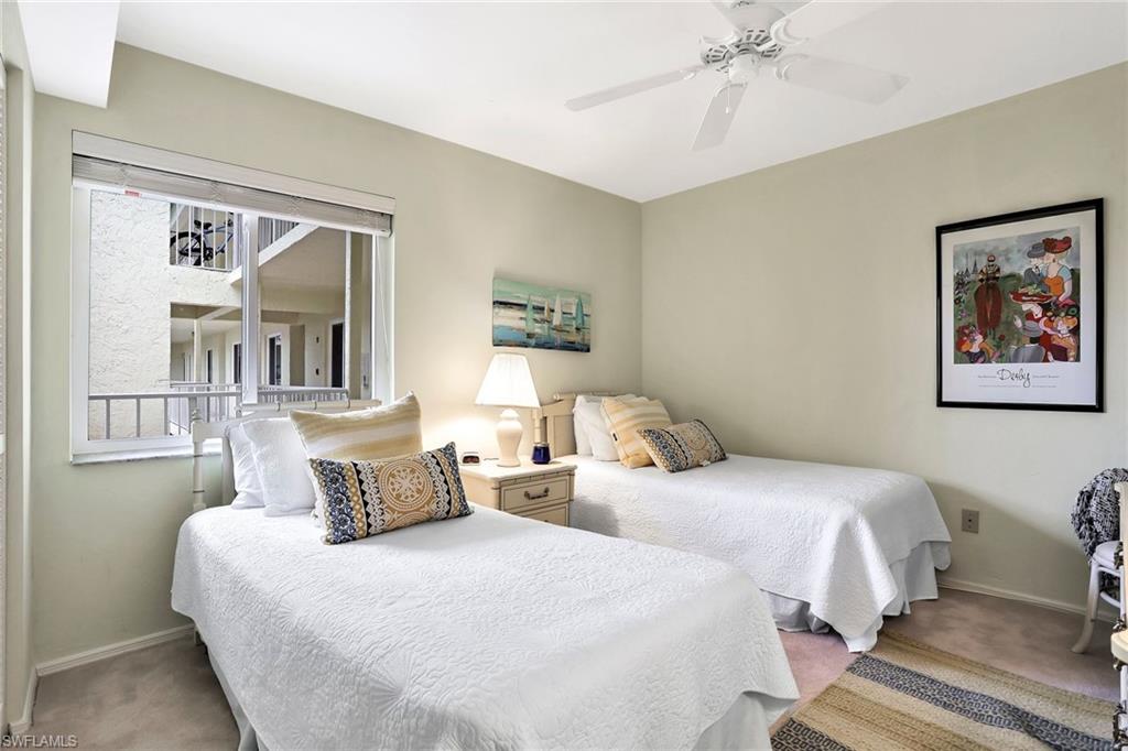 1001 Foxfire Lane, Unit 204 Naples, FL 34104 - Photo 13 of 22 a bedroom with two beds and a painting on the wall