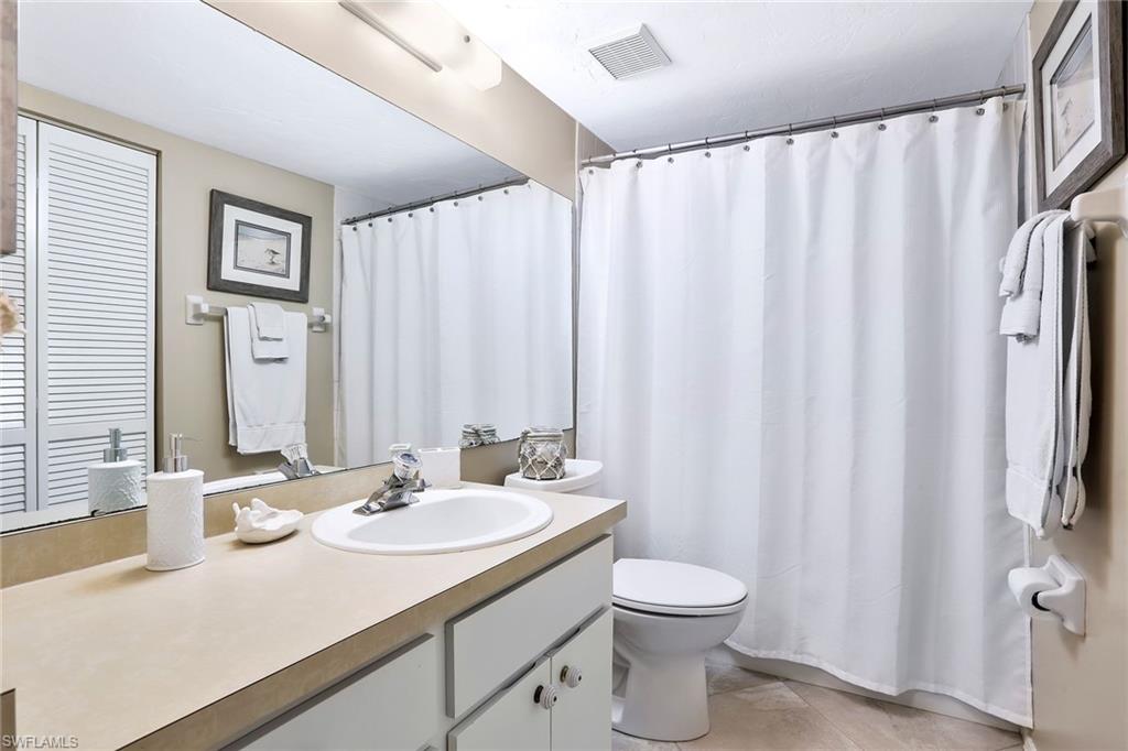 1001 Foxfire Lane, Unit 204 Naples, FL 34104 - Photo 14 of 22 a bathroom with a sink toilet and shower