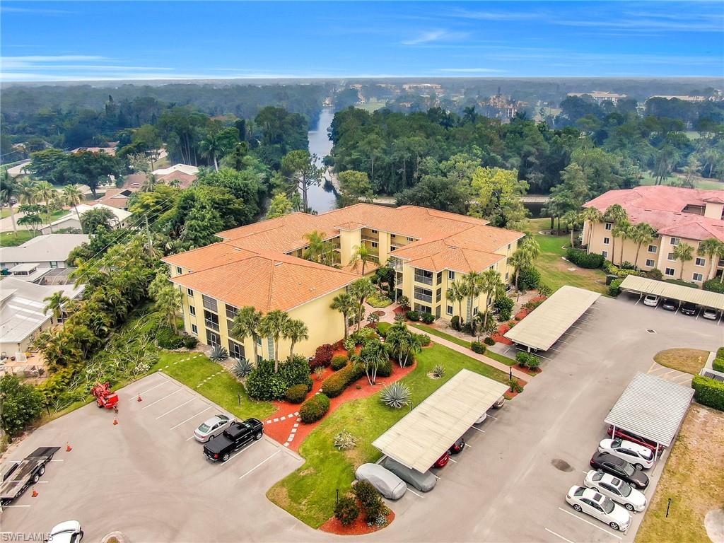 1001 Foxfire Lane, Unit 204 Naples, FL 34104 - Photo 15 of 22 an aerial view of residential houses with outdoor space
