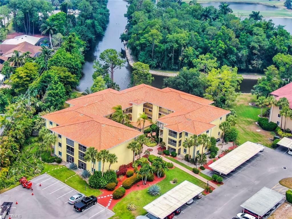1001 Foxfire Lane, Unit 204 Naples, FL 34104 - Photo 18 of 22 an outdoor space with lots of trees
