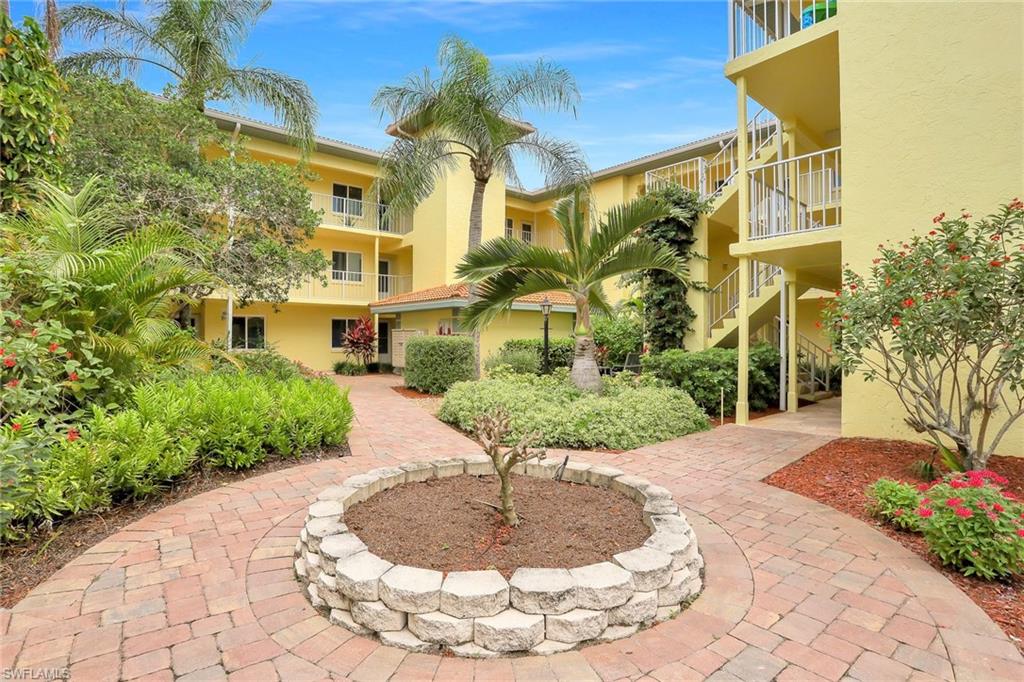 1001 Foxfire Lane, Unit 204 Naples, FL 34104 - Photo 20 of 22 a view of a fountain in front of a building