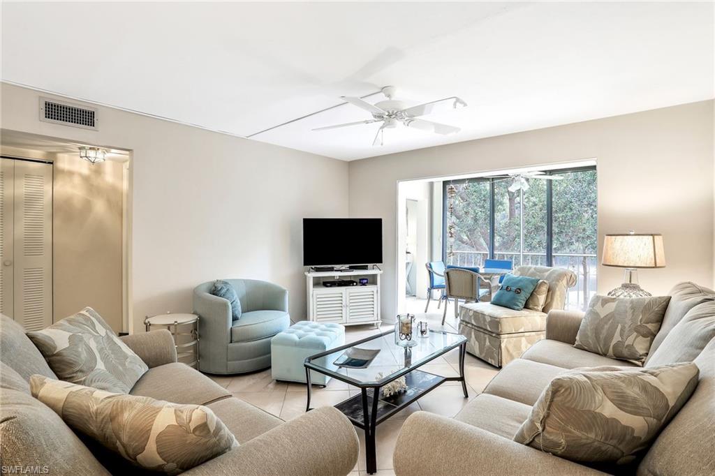1001 Foxfire Lane, Unit 204 Naples, FL 34104 - Photo 3 of 22 a living room with furniture and a flat screen tv