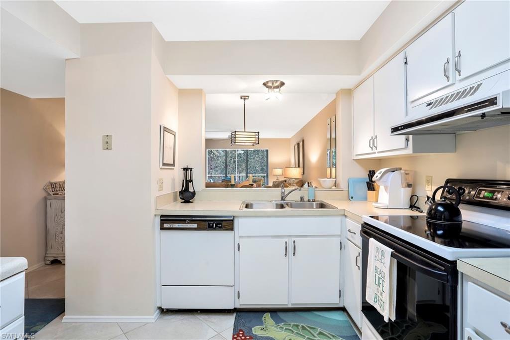 1001 Foxfire Lane, Unit 204 Naples, FL 34104 - Photo 6 of 22 a kitchen with a sink stove and cabinets