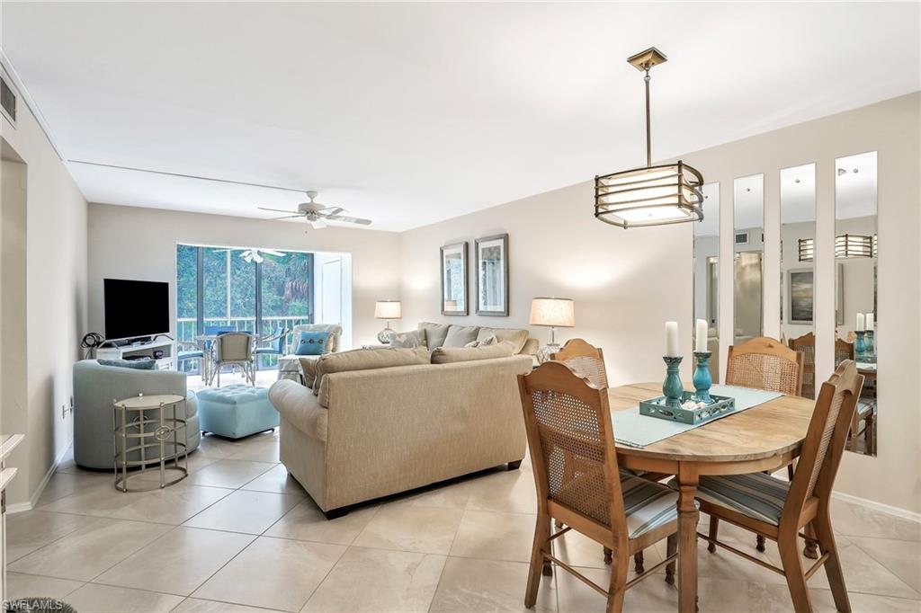 1001 Foxfire Lane, Unit 204 Naples, FL 34104 - Photo 7 of 22 a dining room with furniture and a chandelier